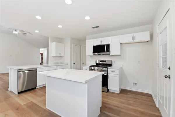 a kitchen with a stove a sink and a refrigerator