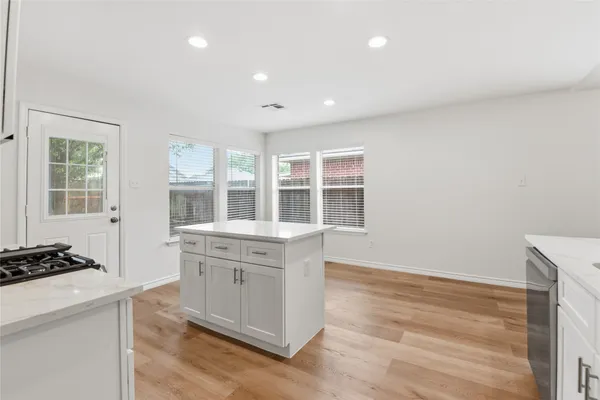 a kitchen with a stove a sink and a refrigerator