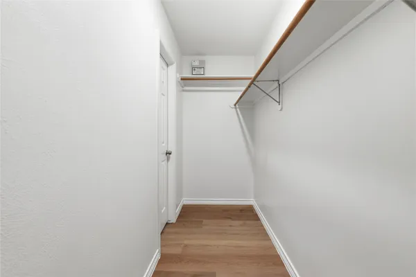 a view of a hallway with wooden floor and entryway