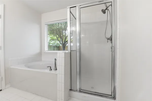 a bathroom with a bathtub and a shower