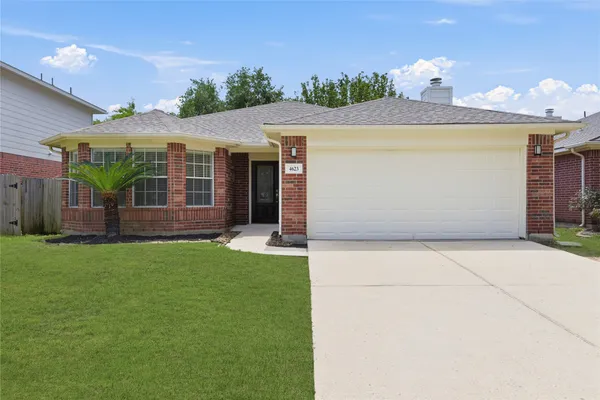 a view of a house with a yard and furniture