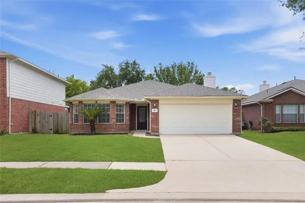 a front view of house with yard and green space