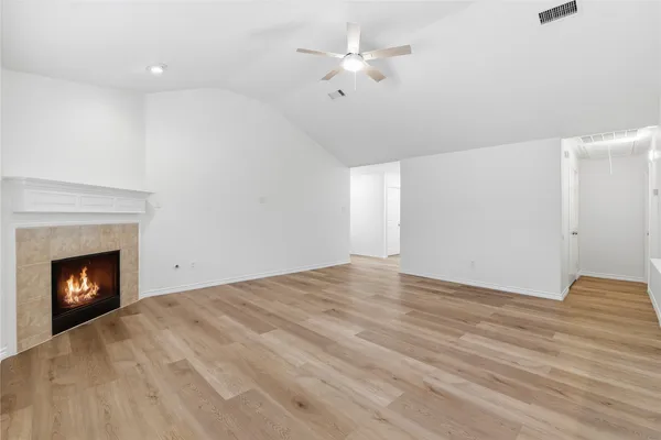 a view of an empty room with a fireplace