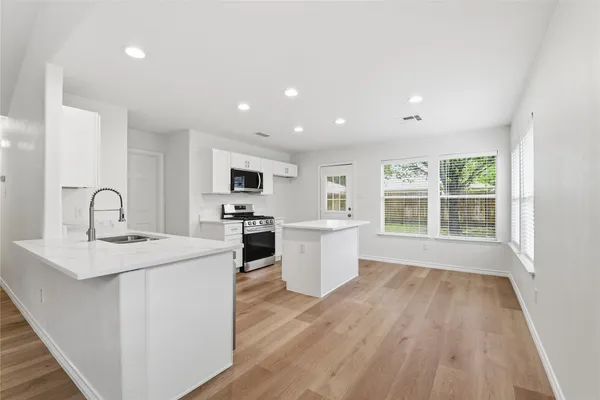 a view of a kitchen with stove and cabinets