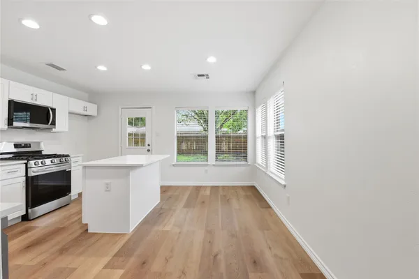 a view of a kitchen with a sink and microwave