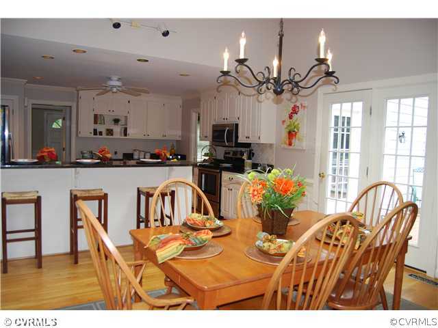 12801 Knightcross Road Midlothian, VA 23113 - Photo 3 of 9 a view of a dining room with furniture and a chandelier