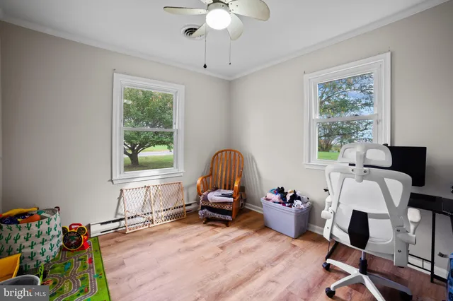 a view of a workspace with furniture and a window