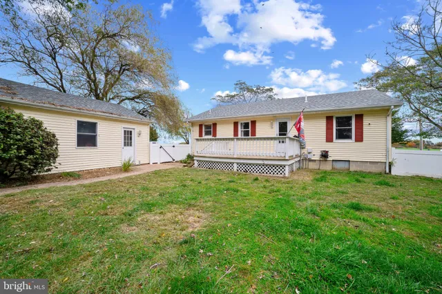 a front view of house with yard and outdoor seating