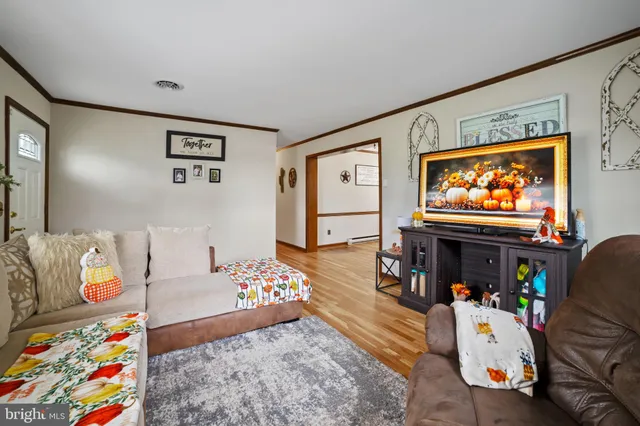 a bedroom with furniture and a flat screen tv
