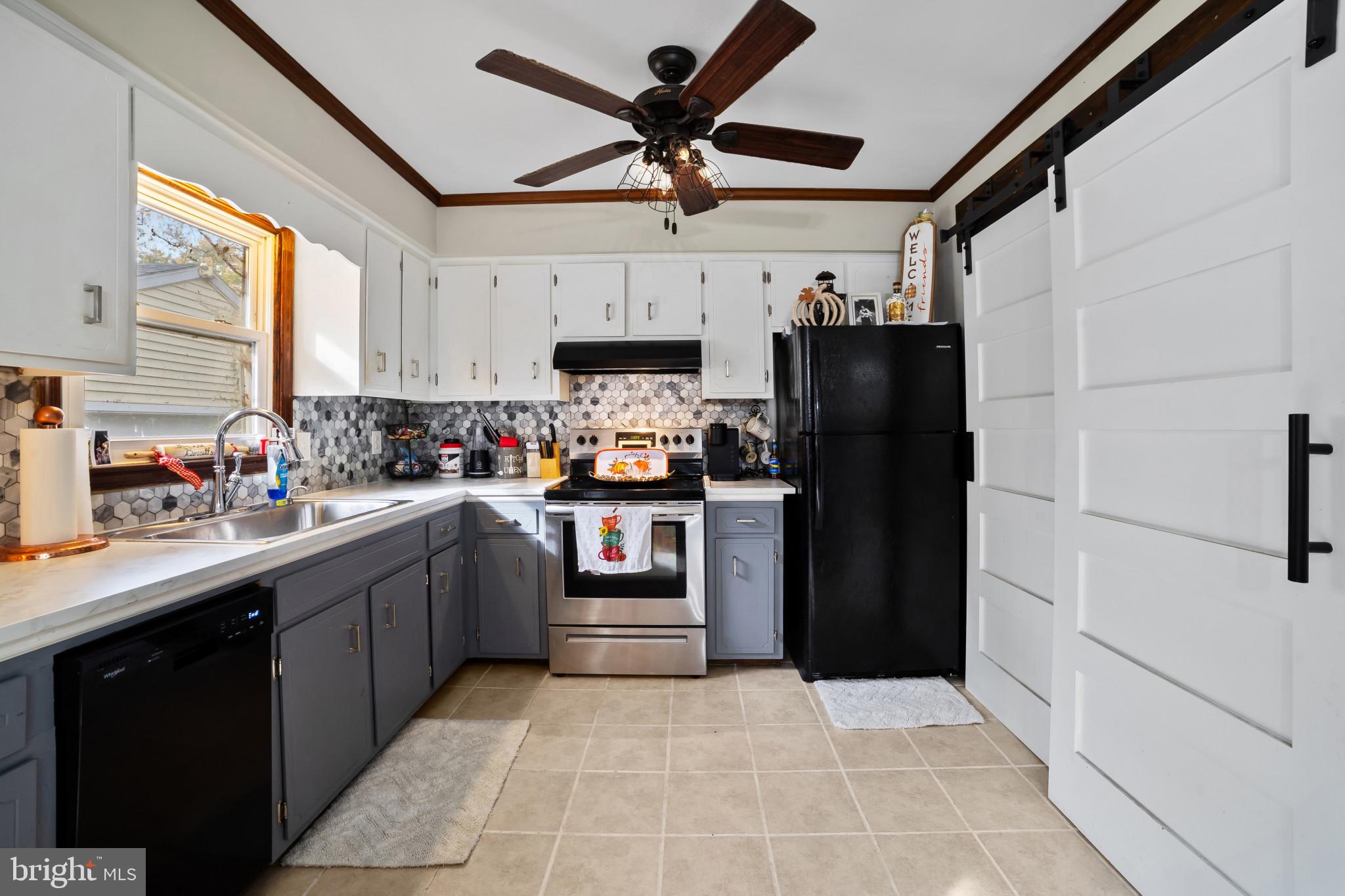 10444 Worton Road Worton, MD 21678 - Photo 8 of 25 a kitchen with a refrigerator and a sink