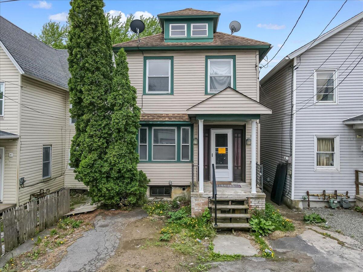 a front view of a house with a garden