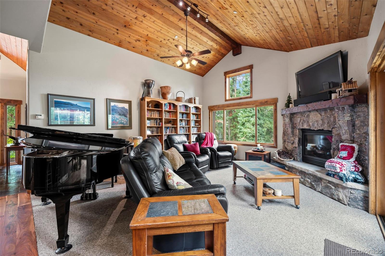 560 Two Cabins Drive Silverthorne, CO 80498 - Photo 11 of 49 a living room with furniture a flat screen tv and a fireplace