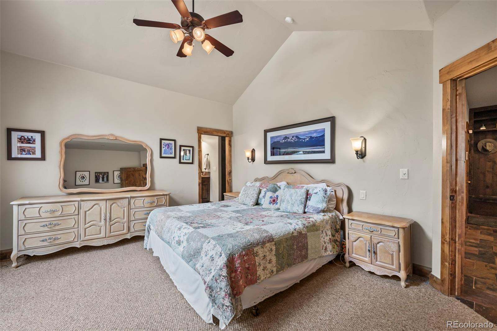 560 Two Cabins Drive Silverthorne, CO 80498 - Photo 15 of 49 a bedroom with a bed and a chandelier