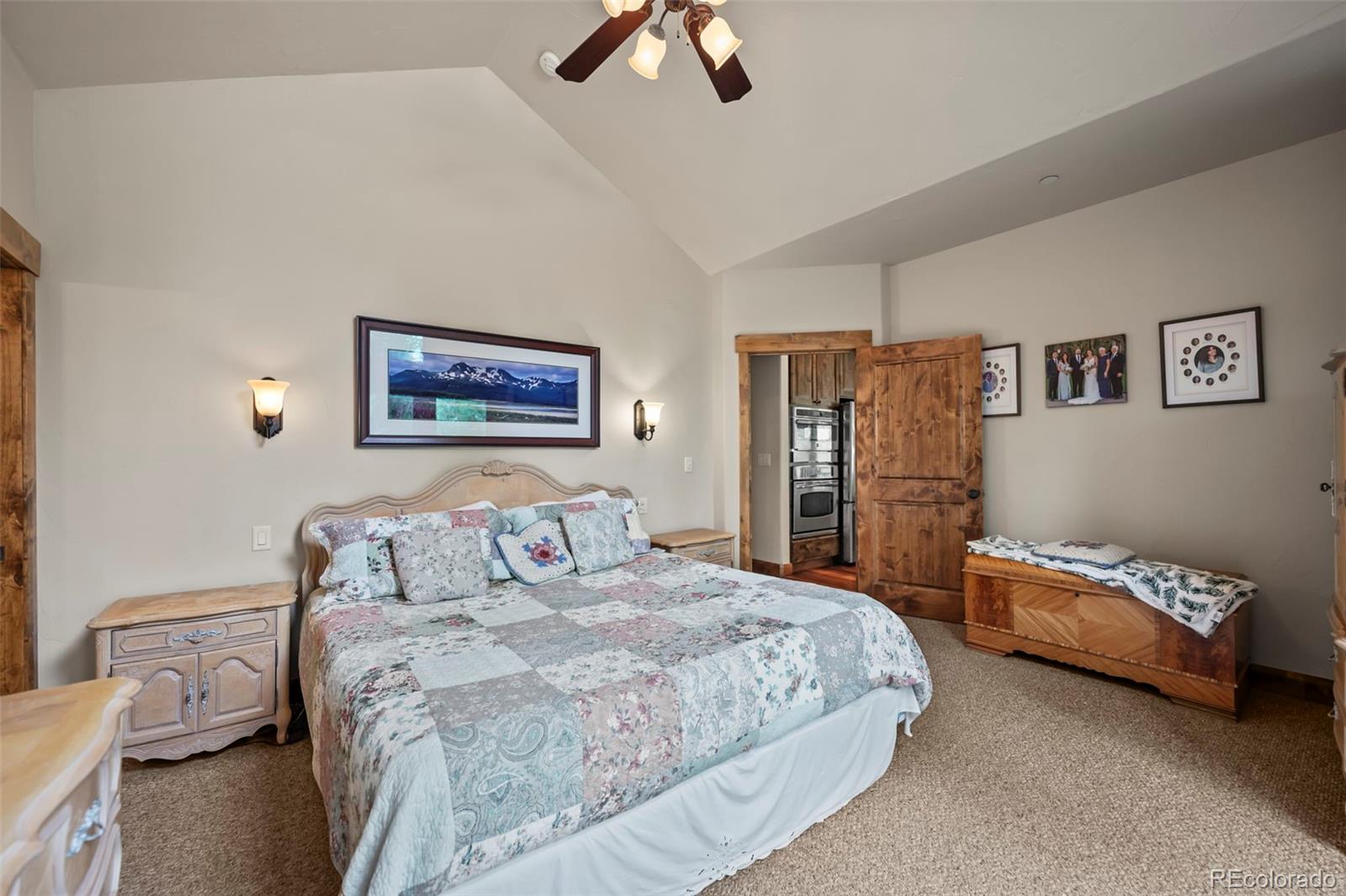 560 Two Cabins Drive Silverthorne, CO 80498 - Photo 16 of 49 a bedroom with a bed and a chandelier