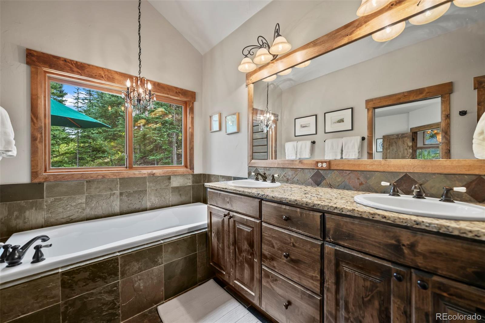 560 Two Cabins Drive Silverthorne, CO 80498 - Photo 17 of 49 a bathroom with a granite countertop sink and a large mirror