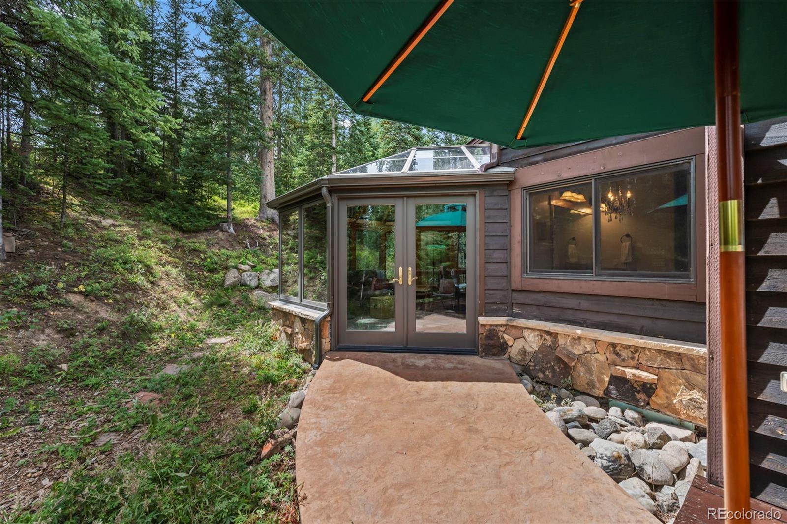 560 Two Cabins Drive Silverthorne, CO 80498 - Photo 20 of 49 a front view of a house with a garden