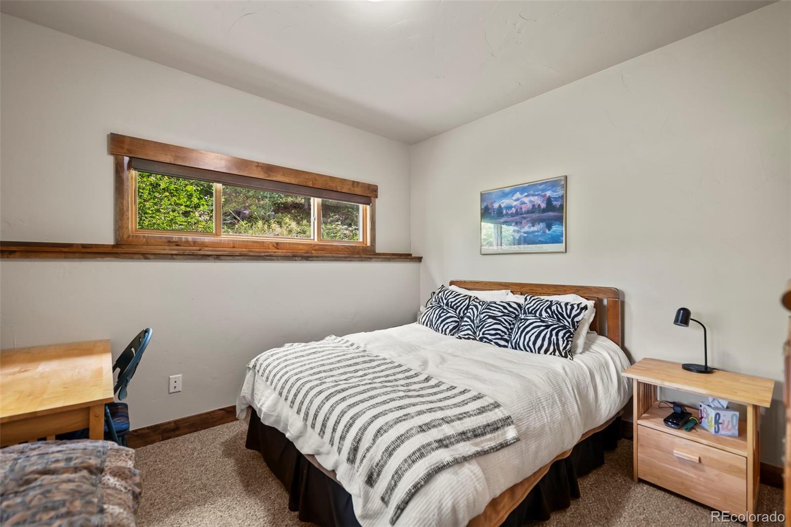 560 Two Cabins Drive Silverthorne, CO 80498 - Photo 25 of 49 a bedroom with a bed and a table in it