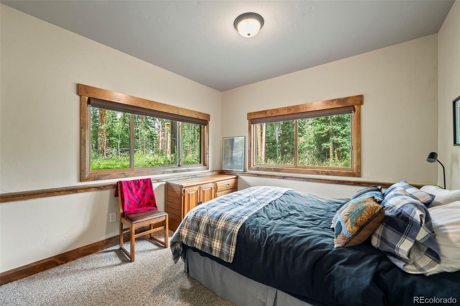 560 Two Cabins Drive Silverthorne, CO 80498 - Photo 27 of 49 a bed sitting in a bedroom next to a window
