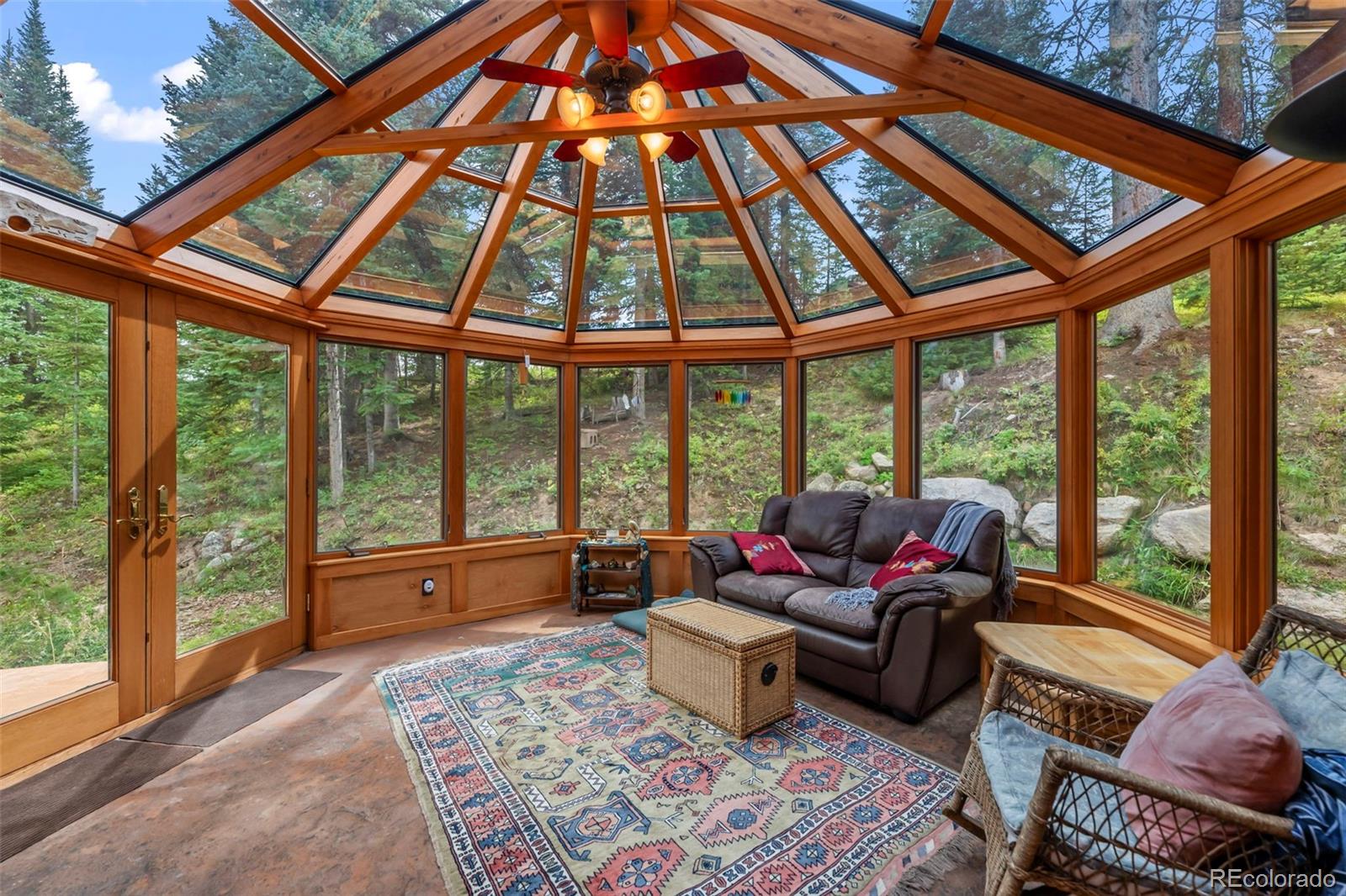 560 Two Cabins Drive Silverthorne, CO 80498 - Photo 30 of 49 a living room with furniture and floor to ceiling windows