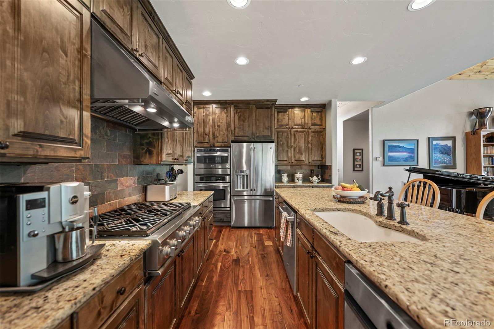 560 Two Cabins Drive Silverthorne, CO 80498 - Photo 7 of 49 a kitchen with stainless steel appliances granite countertop a sink stove and refrigerator