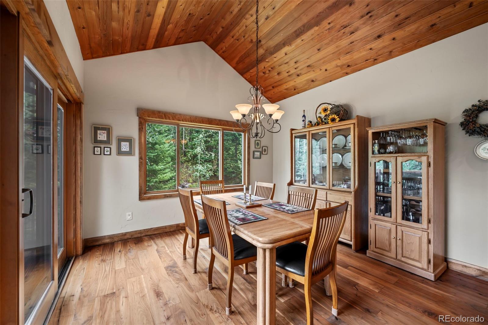 560 Two Cabins Drive Silverthorne, CO 80498 - Photo 9 of 49 a view of a dining room with furniture window and wooden floor