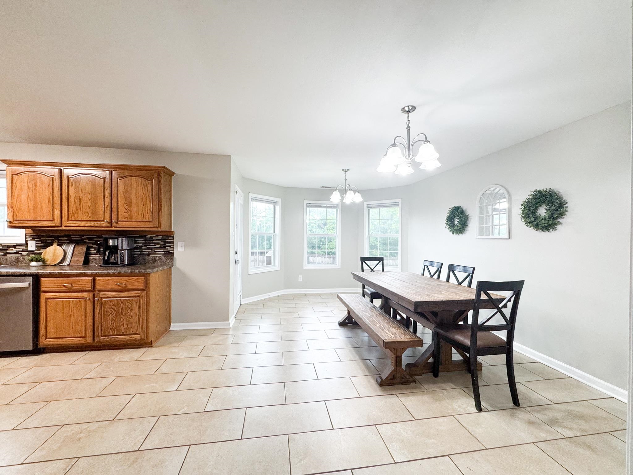 4776 Campground Road Munford, TN 38058 - Photo 4 of 25 a dining room with granite countertop a stove a sink a dining table and chairs