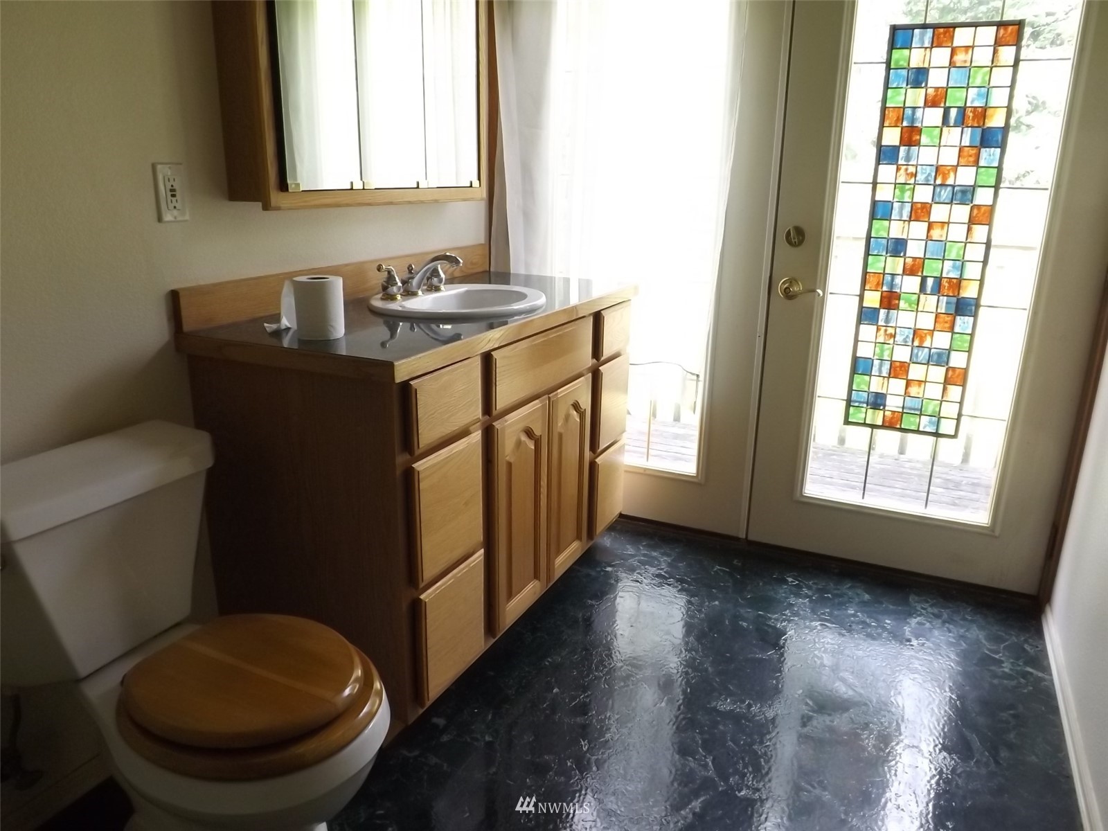 372 Olson Road Sequim, WA 98382 - Photo 13 of 22 a bathroom with a granite countertop toilet sink and mirror