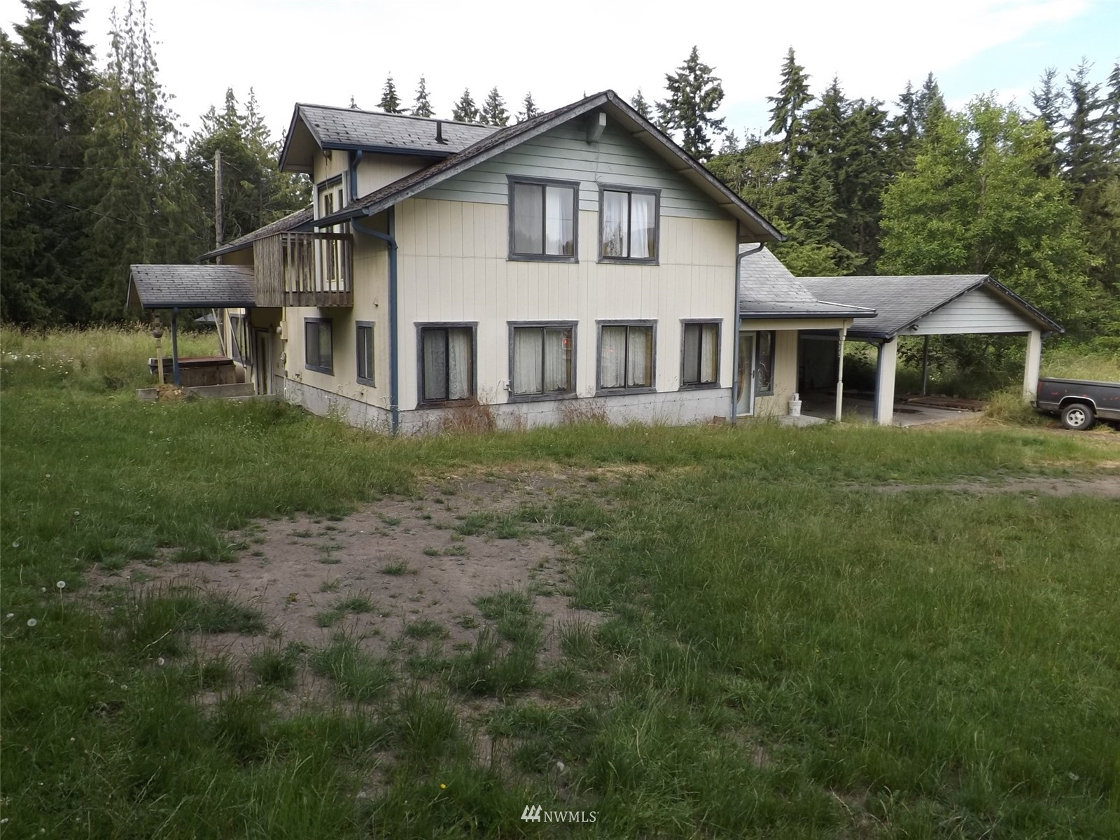 372 Olson Road Sequim, WA 98382 - Photo 2 of 22 a front view of a house with a garden