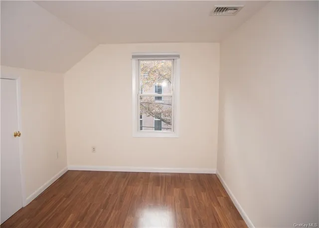 a kitchen with a sink cabinets and wooden floor