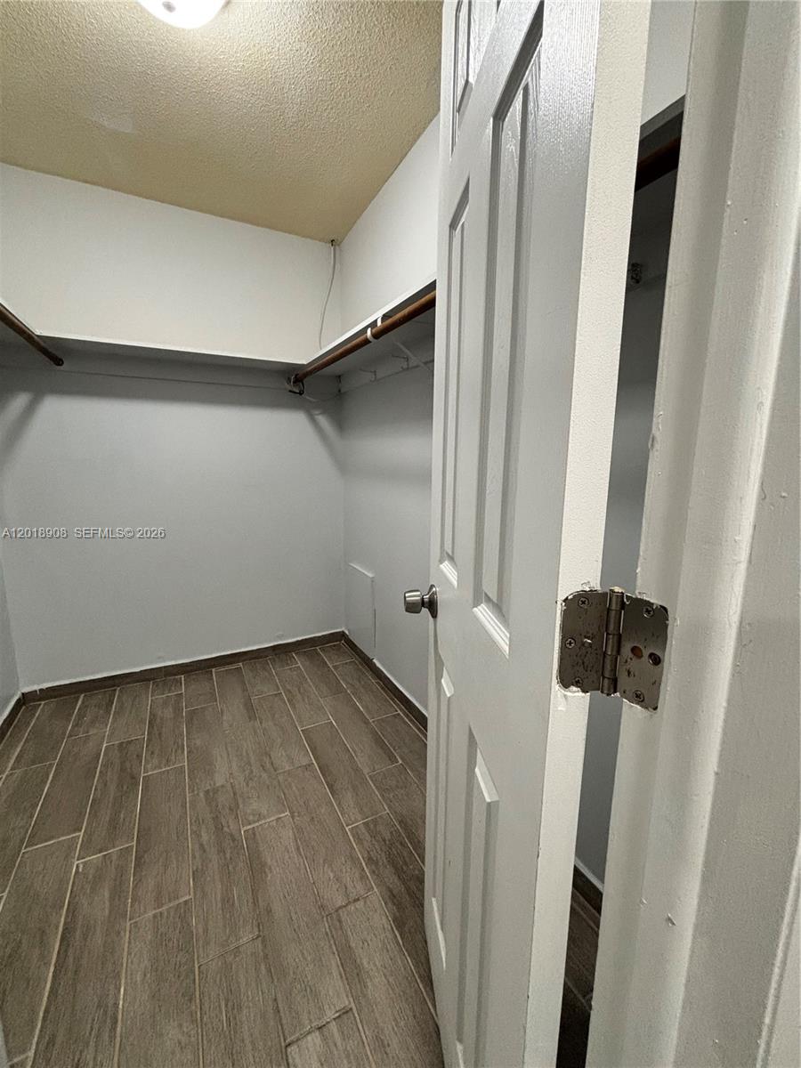 1480 East Sample Road, Unit 209 Pompano Beach, FL 33064 - Photo 21 of 24 a view of a room with wooden floor and staircase