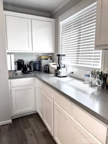 a kitchen with a sink a window and cabinets