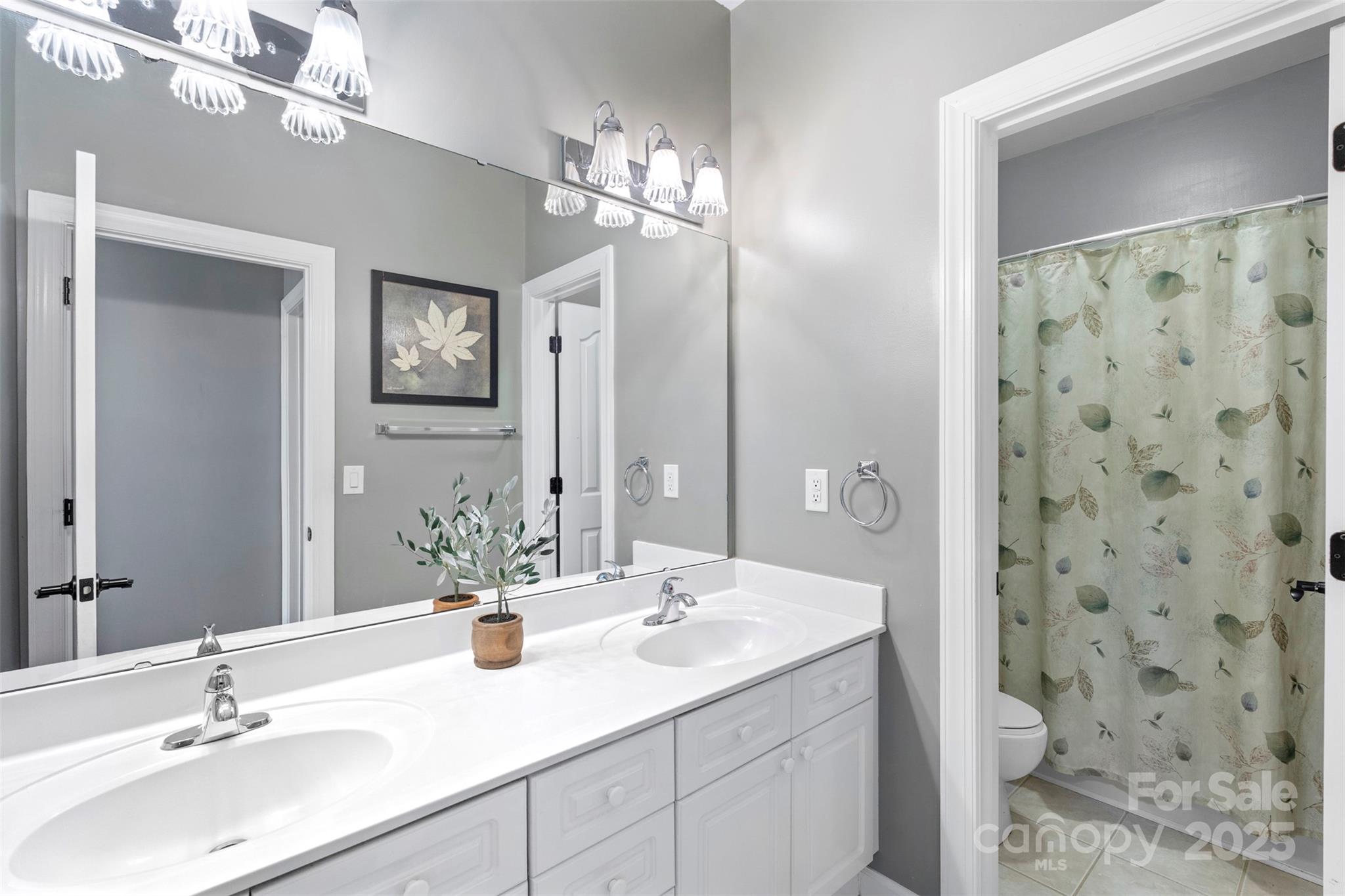 6006 Casswell Circle Matthews, NC 28104 - Photo 28 of 47 a bathroom with a double vanity sink mirror and toilet