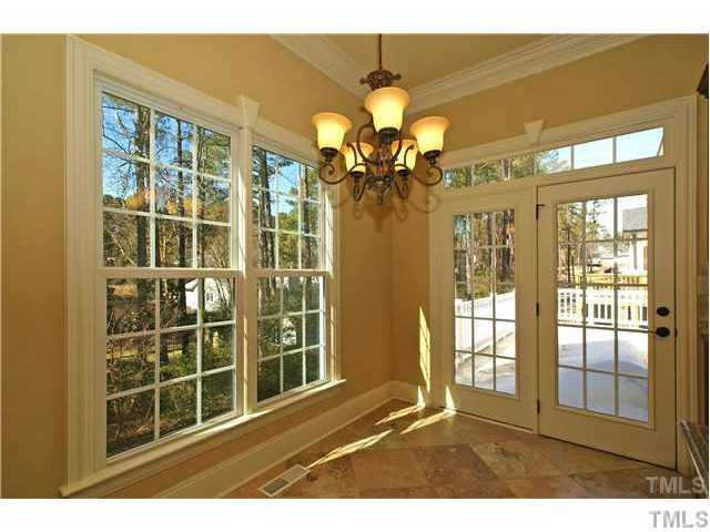 7329 Newport Avenue Raleigh, NC 27613 - Photo 8 of 17 a view of a living room with a floor to ceiling window and chandelier