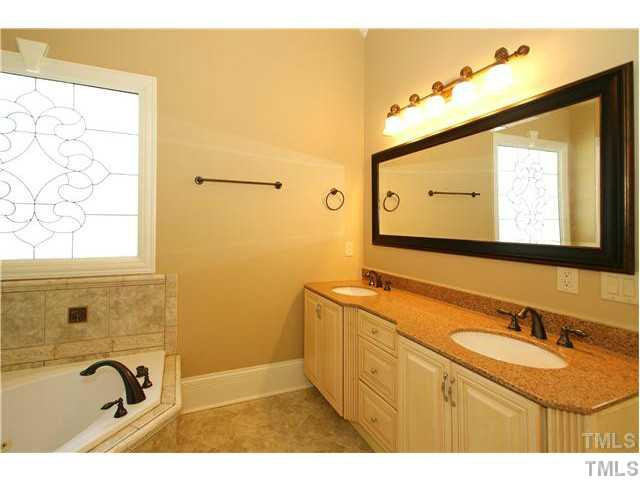 7329 Newport Avenue Raleigh, NC 27613 - Photo 9 of 17 a bathroom with a sink and a mirror