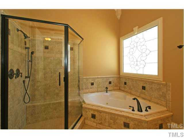 7329 Newport Avenue Raleigh, NC 27613 - Photo 10 of 17 a bathroom with a bath tub and a shower