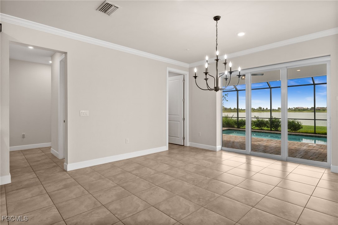 42346 Waterfront Way Punta Gorda, FL 33982 - Photo 11 of 46 an empty room with chandelier and living room view