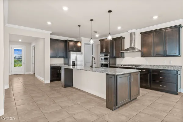a large kitchen with kitchen island a sink stainless steel appliances and cabinets
