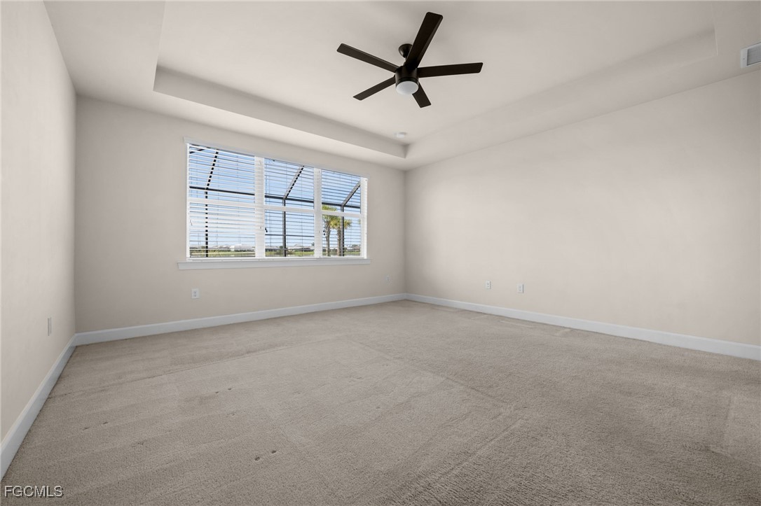 42346 Waterfront Way Punta Gorda, FL 33982 - Photo 22 of 46 an empty room with windows and ceiling fan