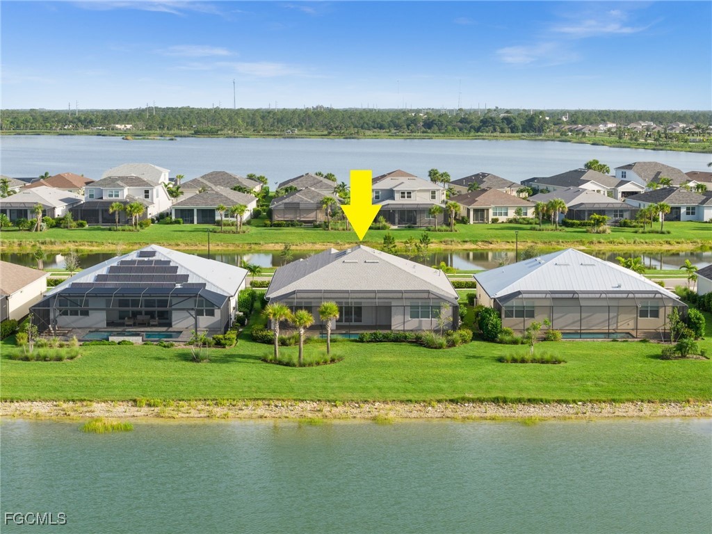 42346 Waterfront Way Punta Gorda, FL 33982 - Photo 41 of 46 a view of a lake with lawn chairs and large trees
