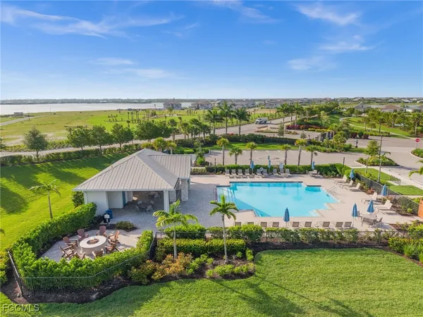 an aerial view of a house with a garden and lake view