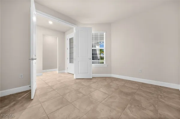 an empty room with windows and closet