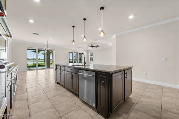 a kitchen with stainless steel appliances granite countertop a stove a sink a oven and a refrigerator