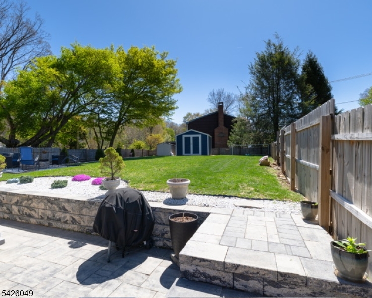 502 Atlas Road Landing, NJ 07850 - Photo 17 of 27 a view of a patio with table and chairs potted plants and large tree