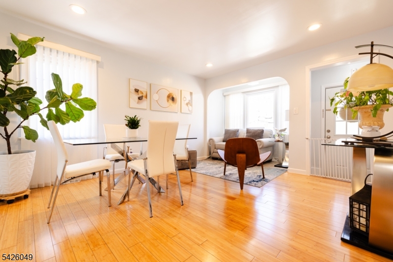 502 Atlas Road Landing, NJ 07850 - Photo 2 of 27 a living room with furniture a dining table with wooden floor and a potted plant