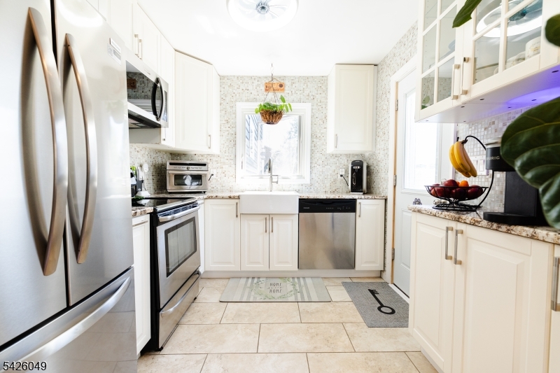 502 Atlas Road Landing, NJ 07850 - Photo 4 of 27 a kitchen with a sink stainless steel appliances and cabinets