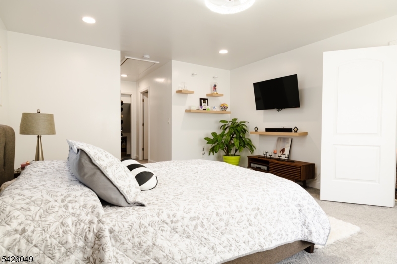 502 Atlas Road Landing, NJ 07850 - Photo 7 of 27 a bedroom with a bed and a flat screen tv