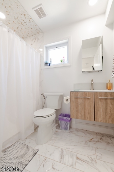 502 Atlas Road Landing, NJ 07850 - Photo 9 of 27 a bathroom with a toilet a sink and mirror