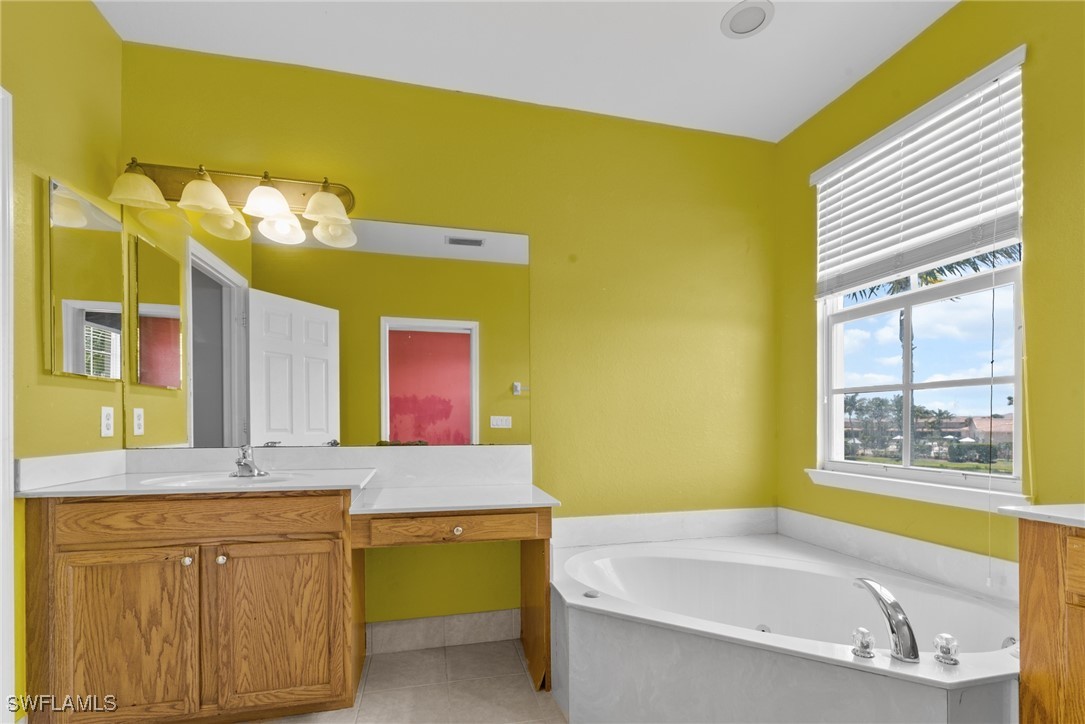 4031 Cherrybrook Loop Fort Myers, FL 33966 - Photo 13 of 34 a bathroom with a granite countertop sink and a bathtub