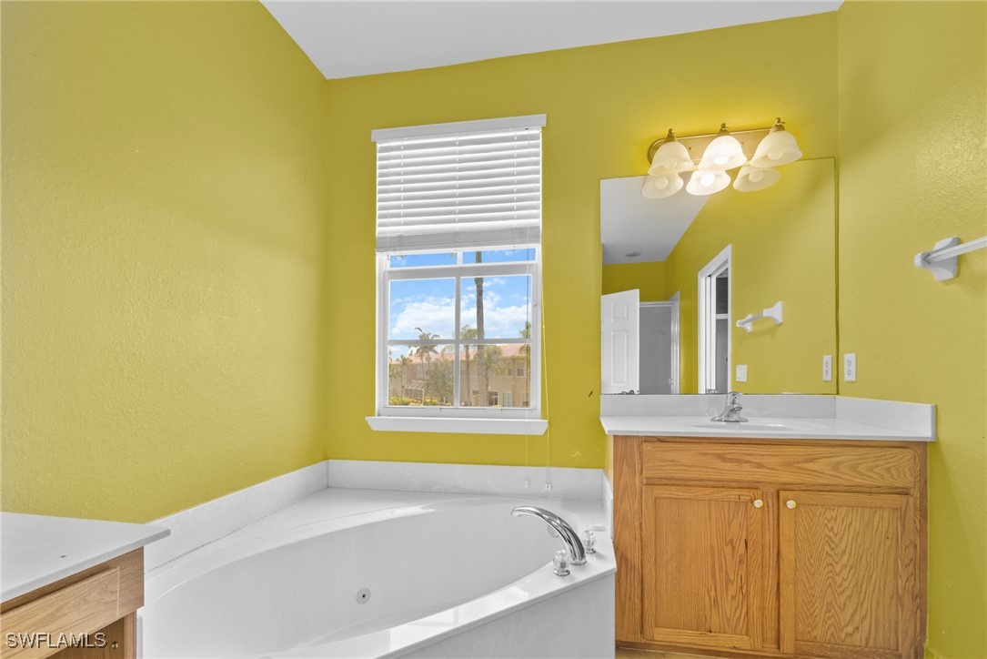 4031 Cherrybrook Loop Fort Myers, FL 33966 - Photo 14 of 34 a bathroom with a granite countertop sink and a bathtub