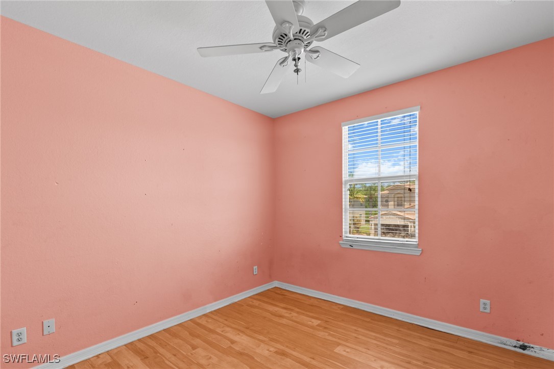 4031 Cherrybrook Loop Fort Myers, FL 33966 - Photo 18 of 34 an empty room with a chandelier fan and windows